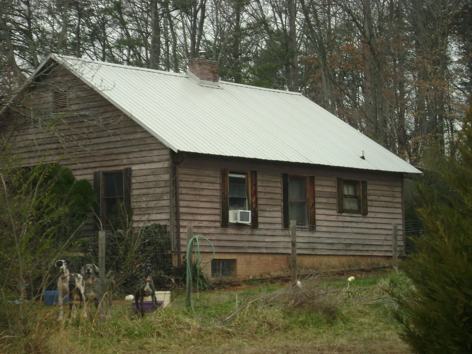 White metal roof on an old wood sided farmhouse, from a Asphalt Shingle Roof Repair job in Byesville